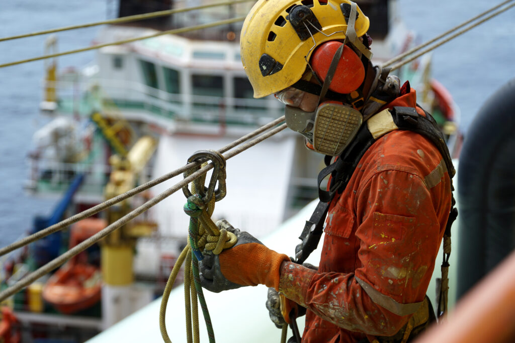 An,Abseiler,Wearing,Personal,Protective,Equipment,(ppe),Such,As,Respiratory