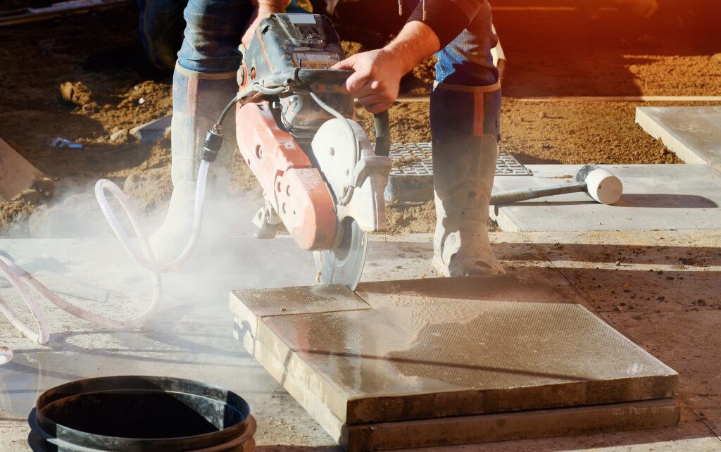 Builder,Cutting,Concrete,Slabs,With,Petrol,Concrete,Saw,And,A